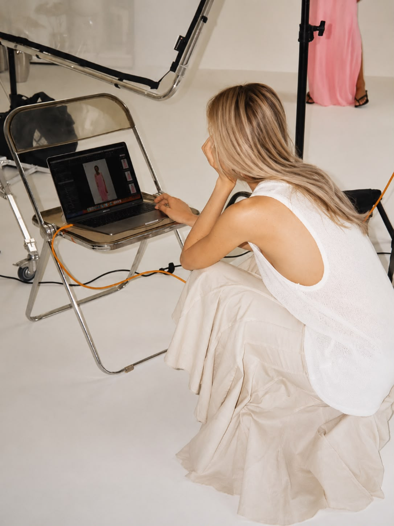 Cala Creative Agency team member reviewing client fashion shoot on laptop